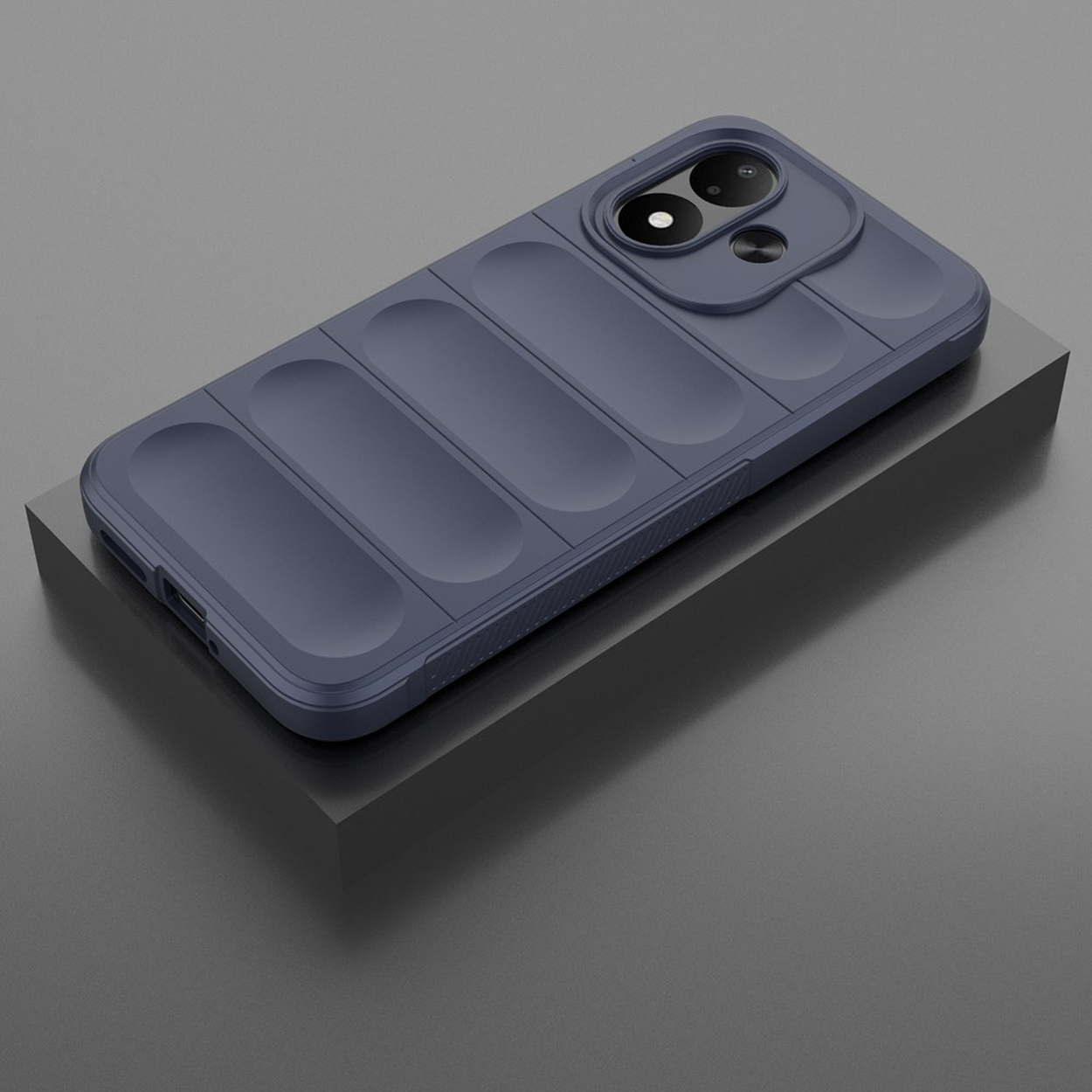 Dark blue puffer-style smartphone case with camera module, resting on a gray block.