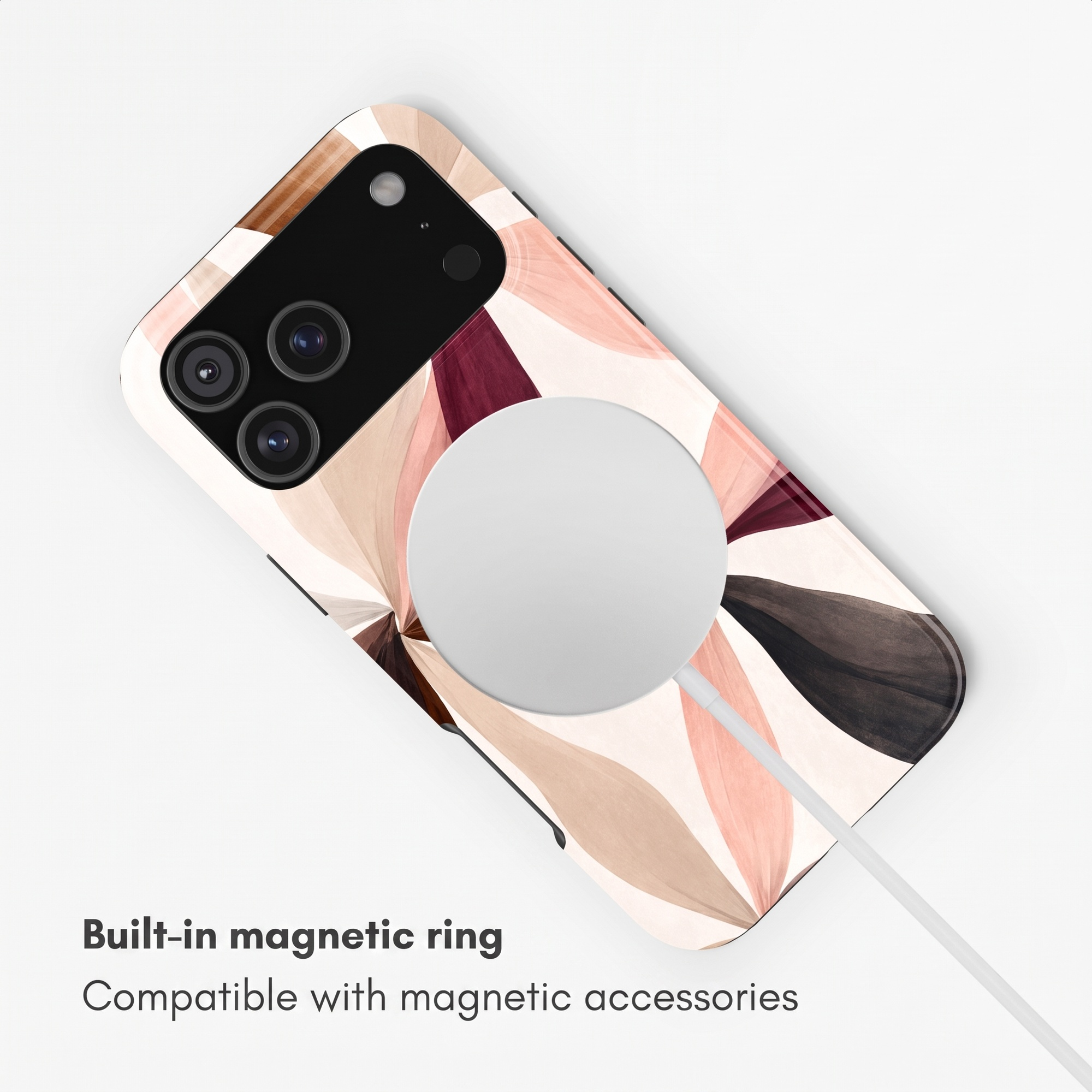 Smartphone mit floralem Muster und integriertem Magnetring für Zubehör auf weißem Hintergrund.