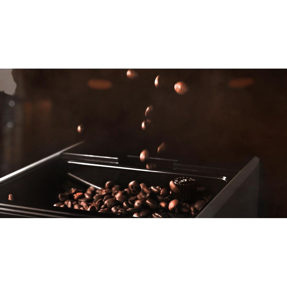 Chicchi di caffè che cadono nel contenitore di una macchina.