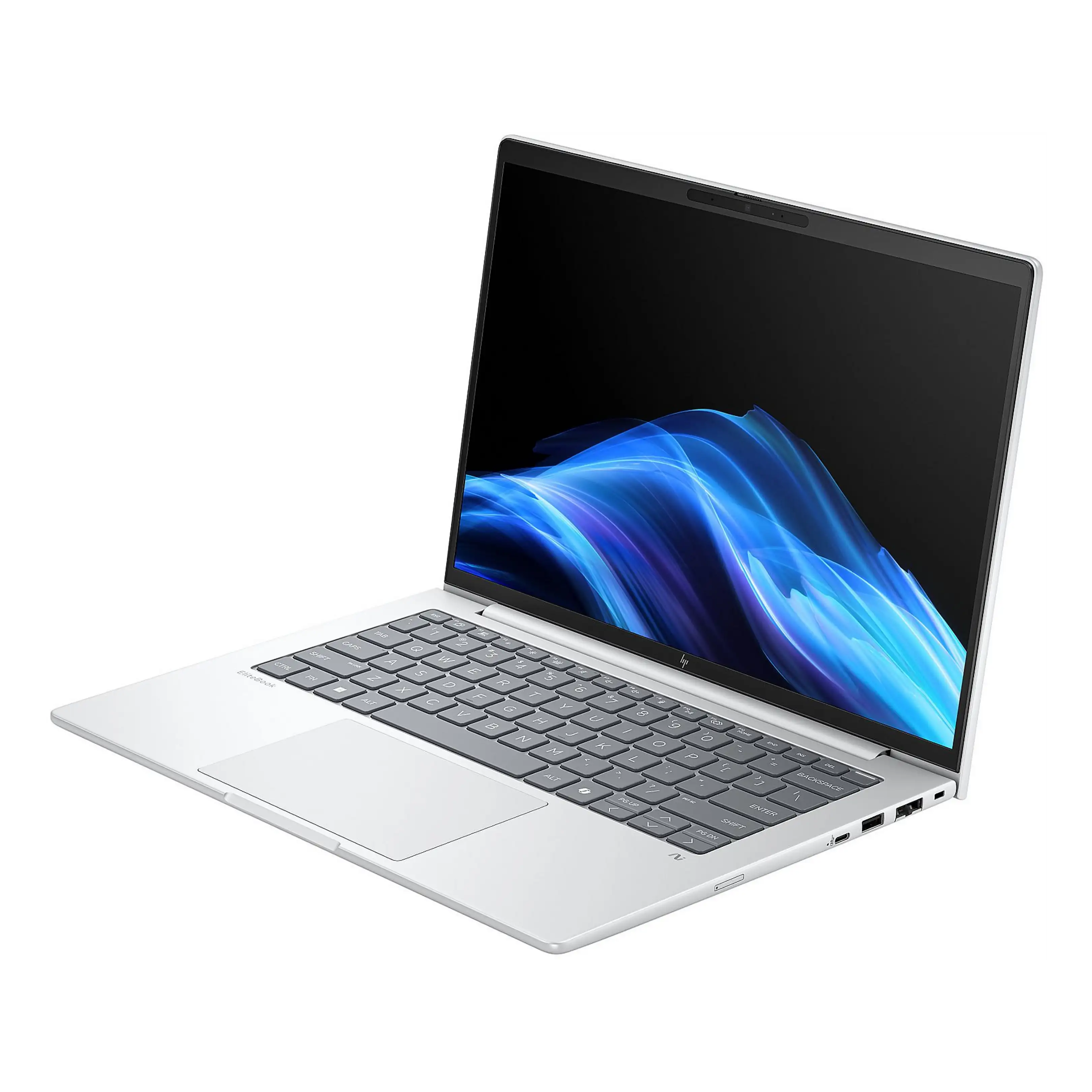 Un laptop argentato con tastiera nera e sfondo a onde blu sullo schermo, isolato su bianco.