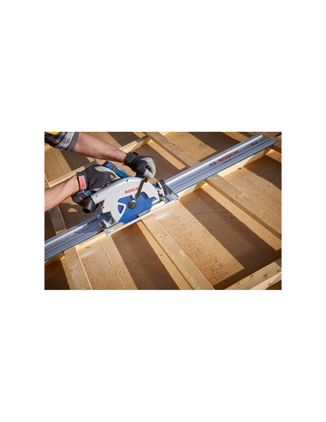 A person uses a Bosch circular saw on a guide rail to cut a wooden beam.