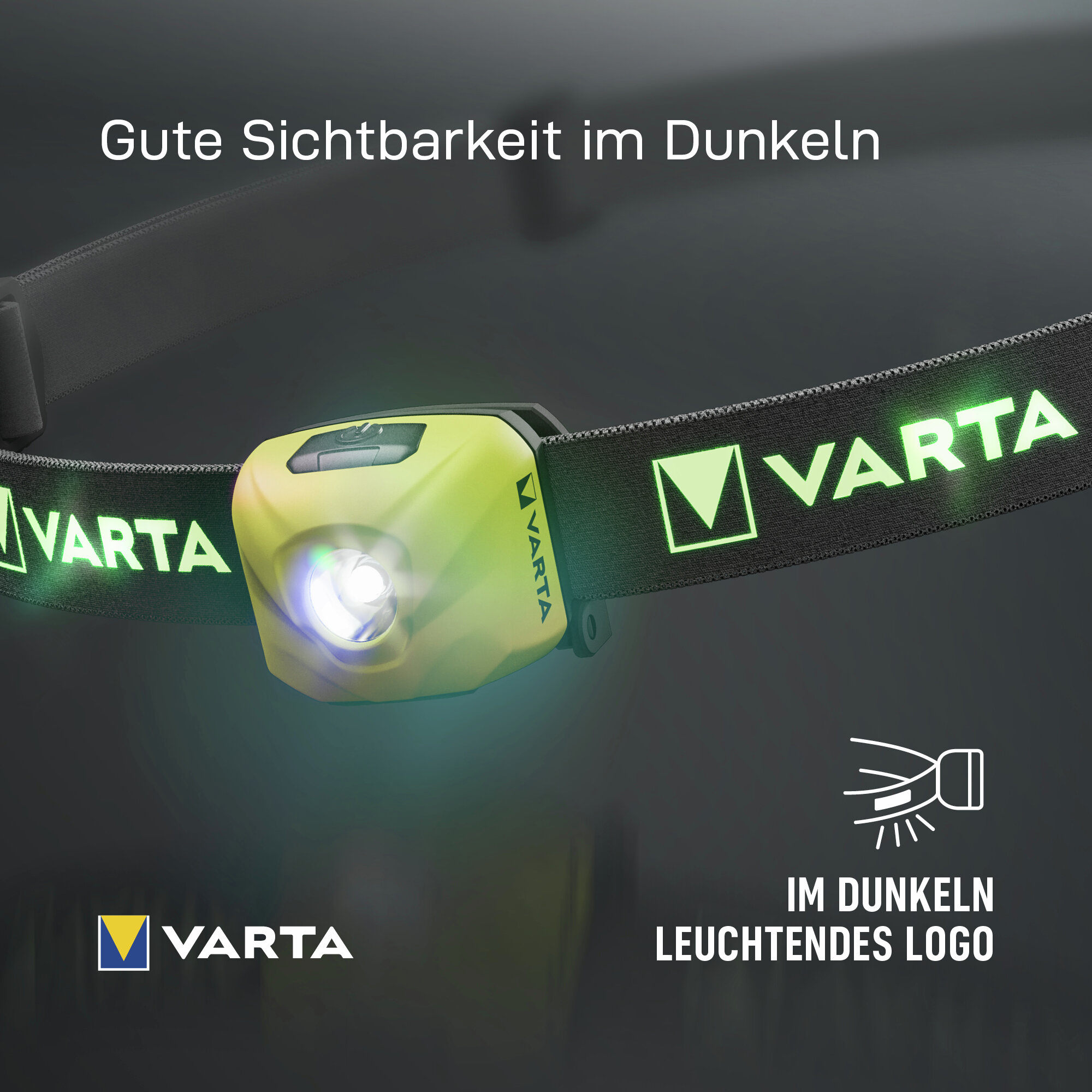 Linterna frontal Varta amarilla con logo brillante en la correa sobre fondo oscuro.