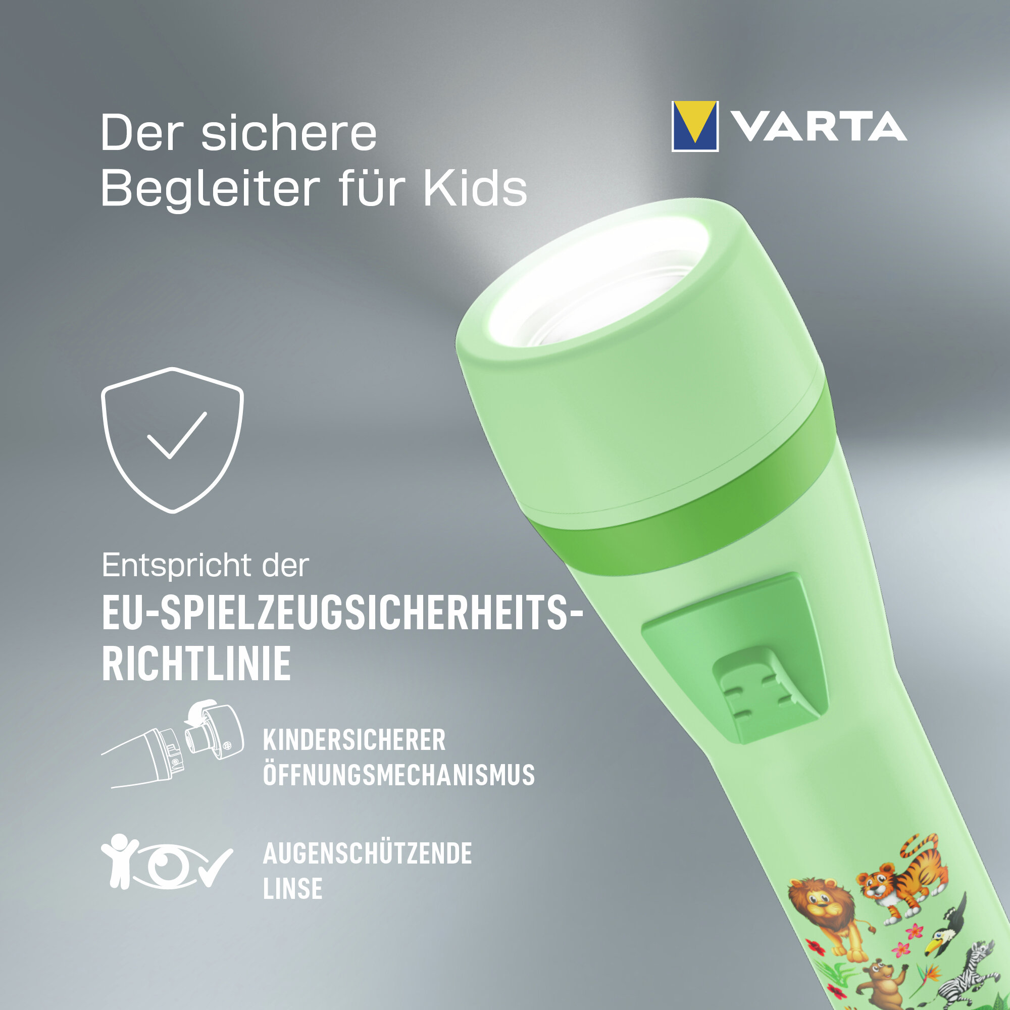 Linterna infantil verde Varta con diseño animal, haz de luz, texto en alemán e iconos de seguridad sobre fondo gris.