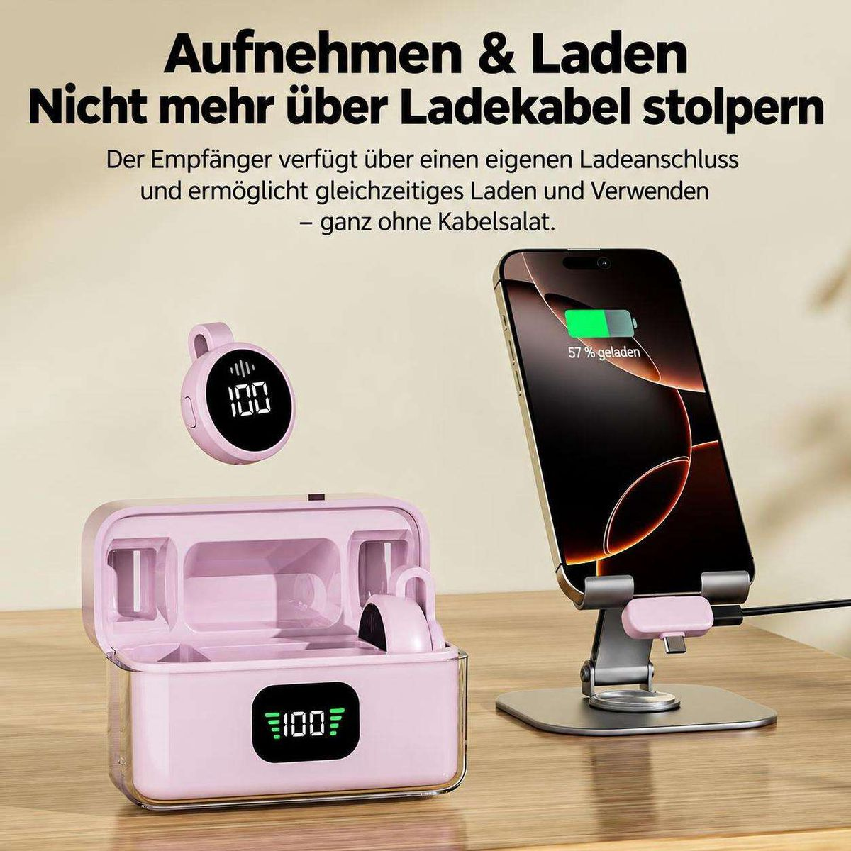 Ein Smartphone und eine pinke Ladestation mit digitaler Prozentanzeige auf einem Holztisch.