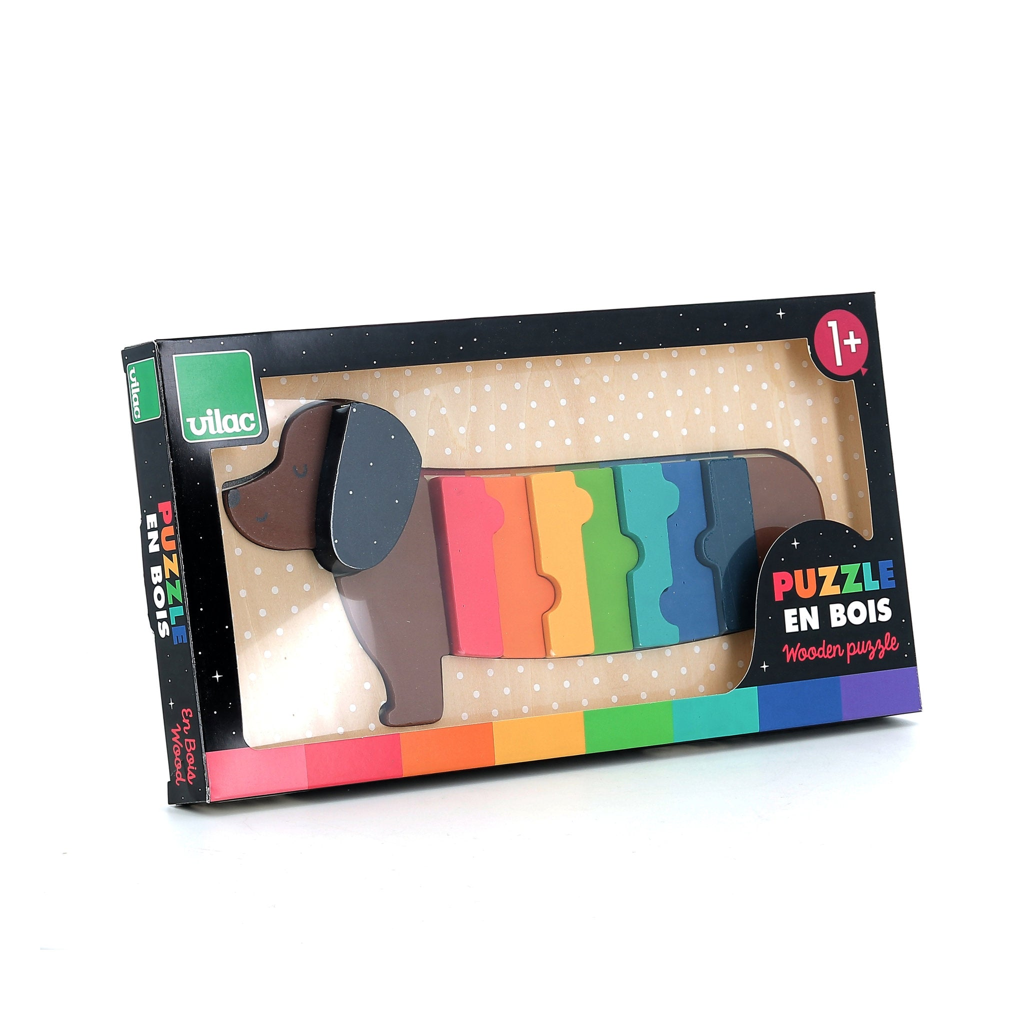 Ein buntes Dackel-Holzpuzzle in einer schwarzen Schachtel auf weißem Grund.