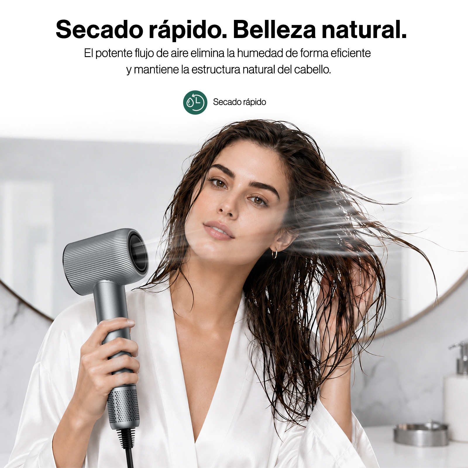 Una mujer en bata seca su cabello mojado con un secador gris moderno.