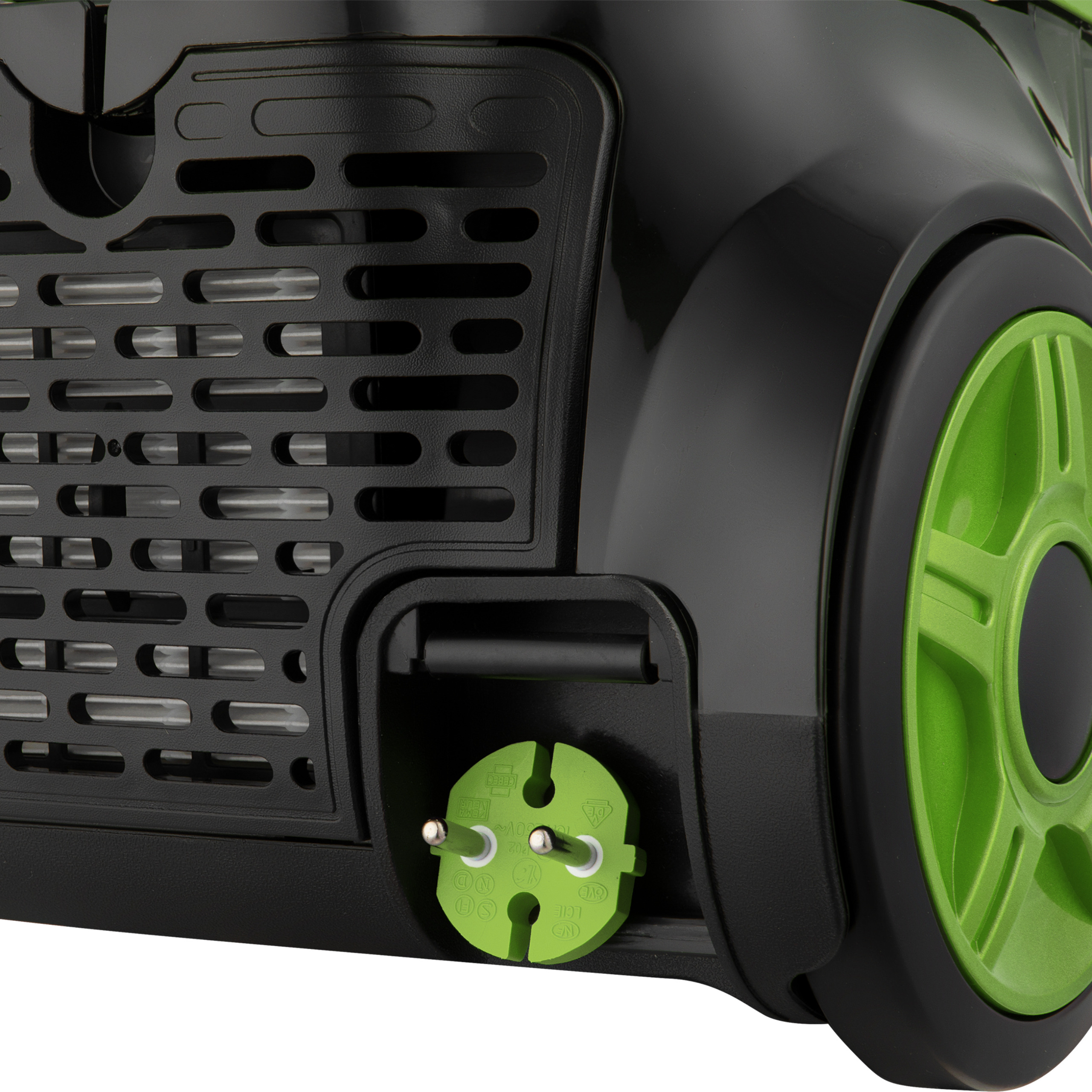 Close-up of a black vacuum cleaner with a green wheel and a plugged-in green power plug.