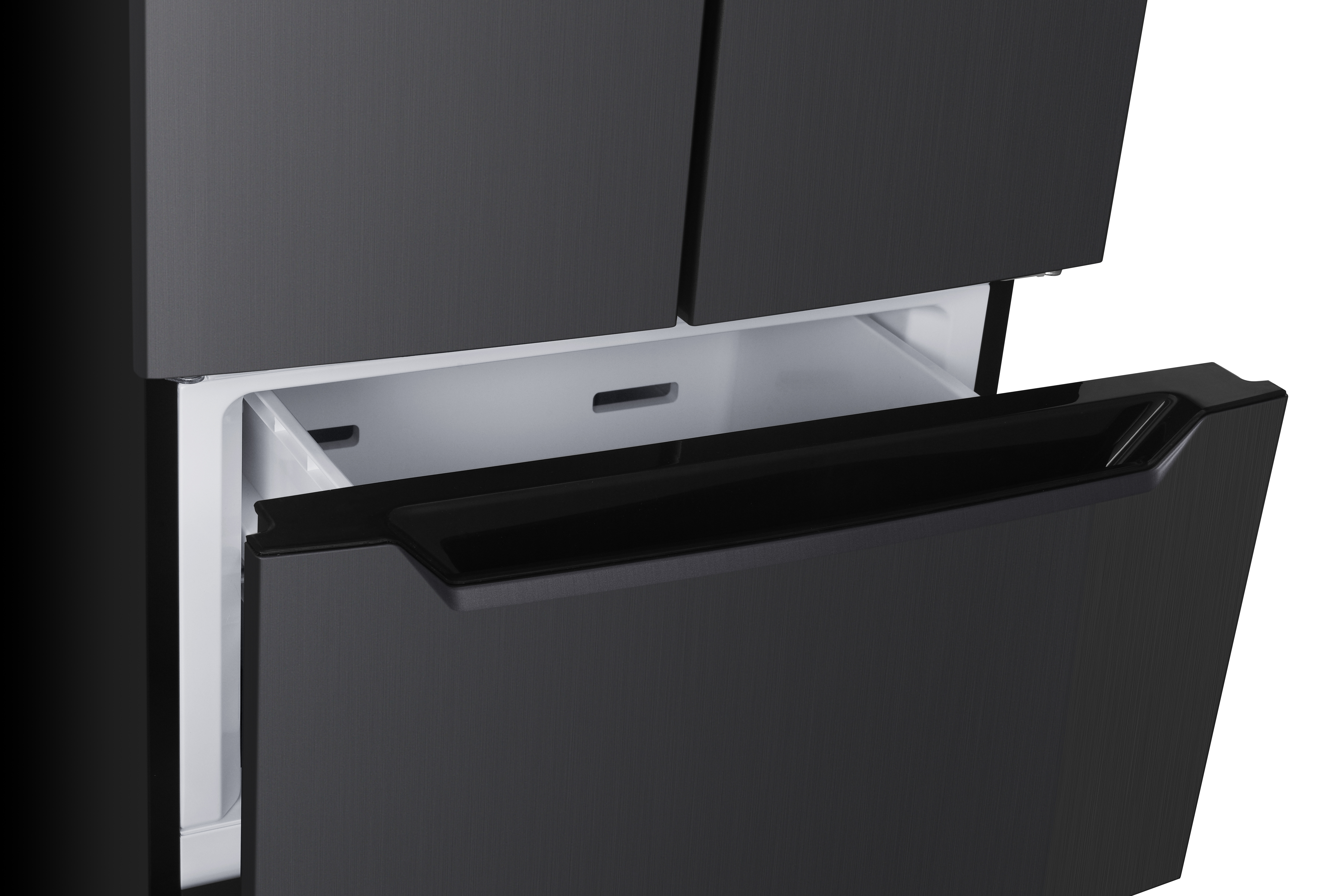 A close-up of a modern dark gray refrigerator with its bottom freezer drawer pulled open, revealing a white interior.