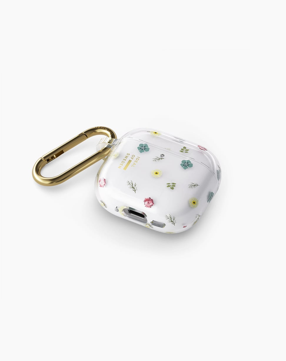 Funda transparente para AirPods con estampado floral y mosquetón dorado sobre fondo blanco.