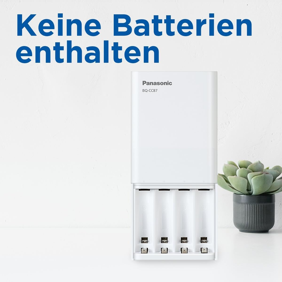 Biała ładowarka Panasonic BQ-CC87 na stole z niemieckim tekstem 'Keine Batterien enthalten'.