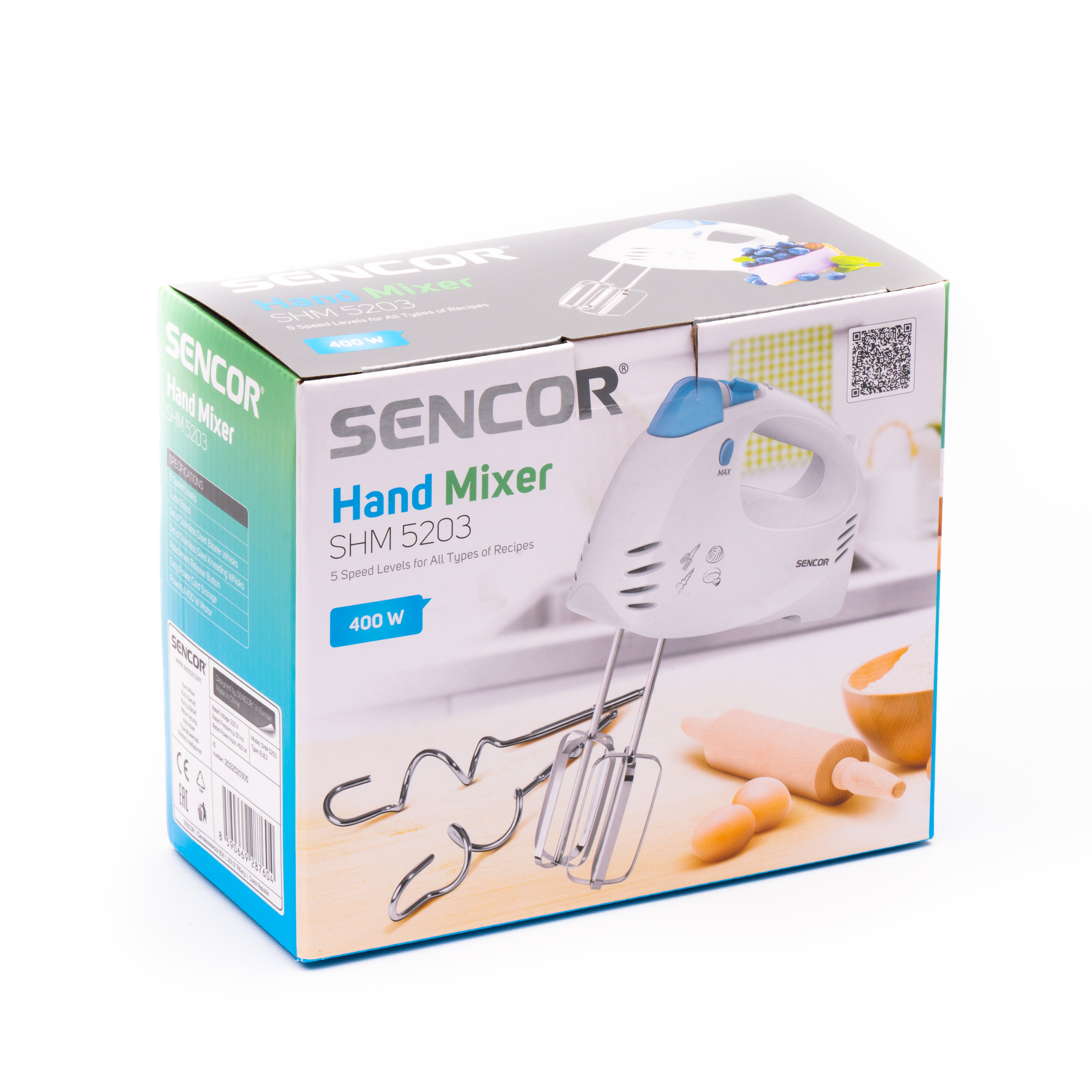 Caja de embalaje para la batidora de mano Sencor SHM 5203, que muestra la batidora blanca, accesorios e ingredientes de repostería.