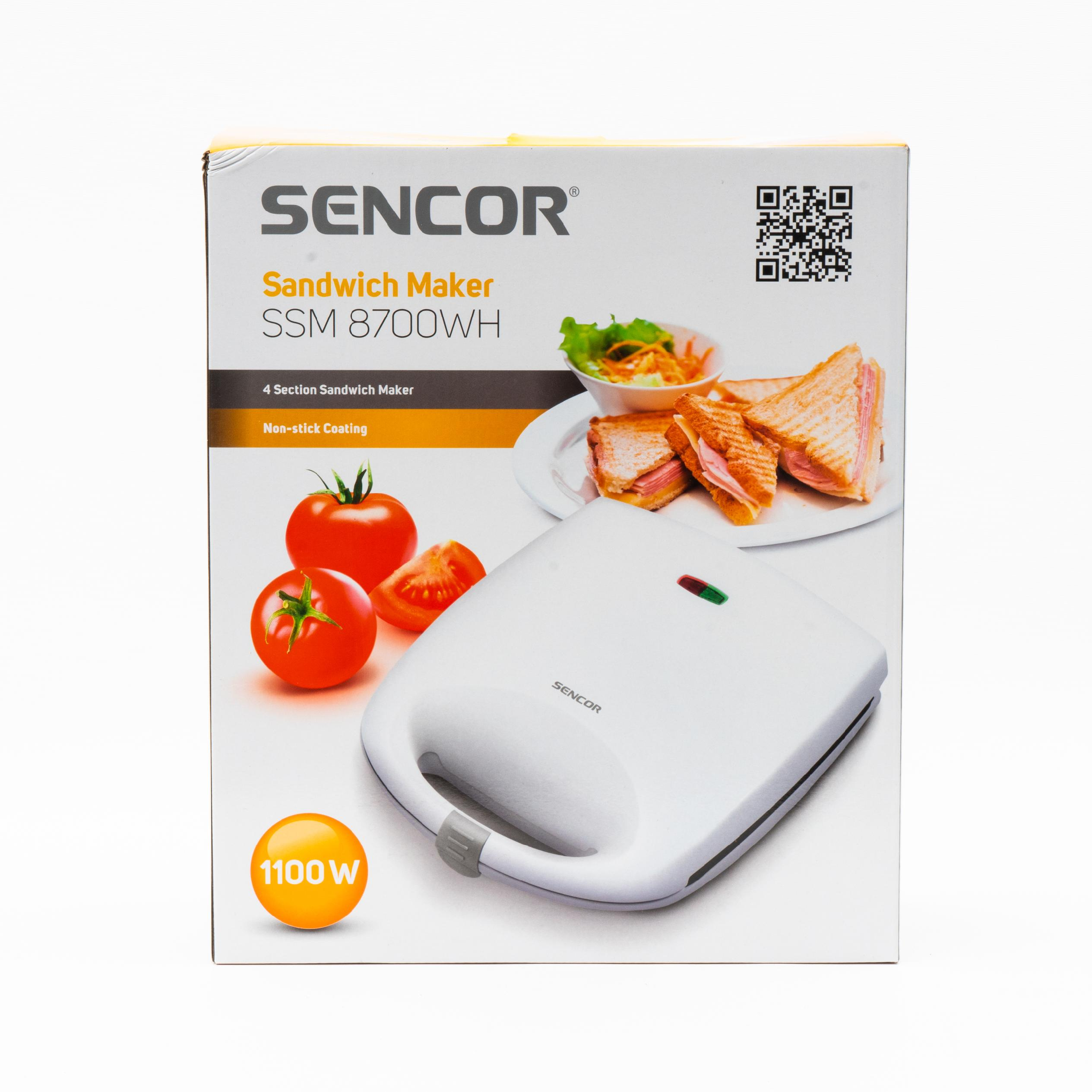 Confezione della piastra per panini Sencor SSM 8700WH con l'apparecchio bianco, panini e pomodori freschi.