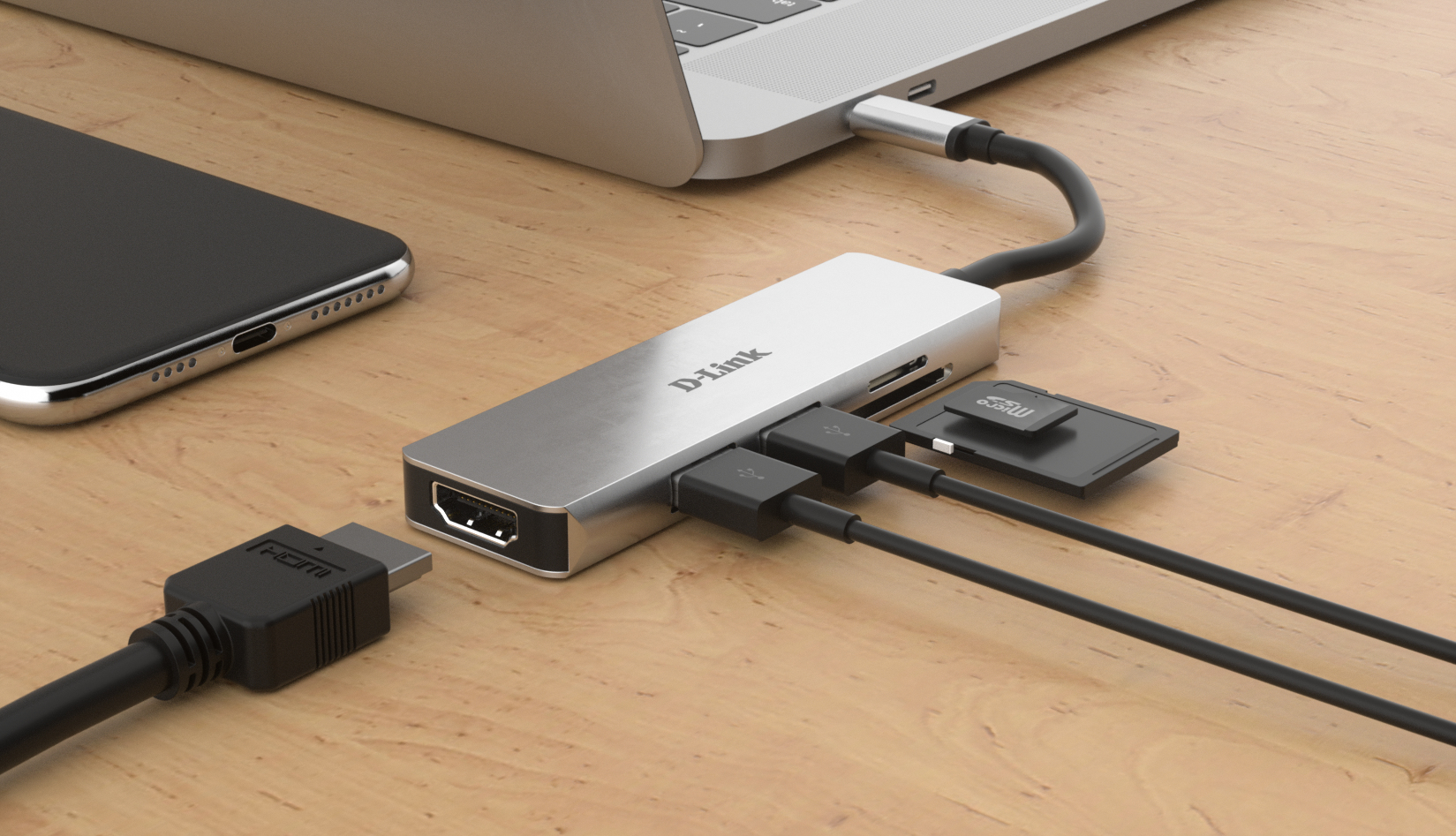 Un hub USB-C D-Link argento con cavi collegati e schede di memoria su una scrivania di legno.