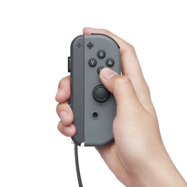 A hand holds a gray Nintendo Switch Joy-Con controller against a white background.