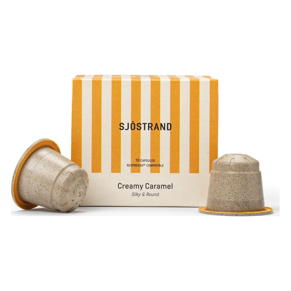 Una scatola di capsule di caffè Sjöstrand Creamy Caramel con due capsule in primo piano.