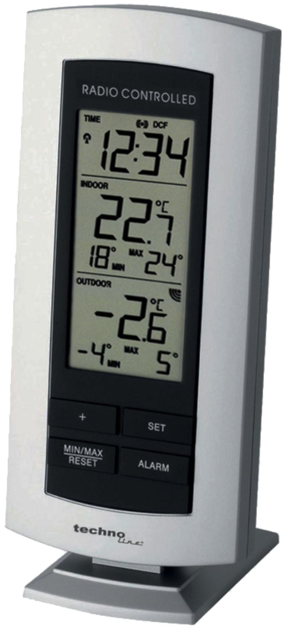Eine silberne digitale Wetterstation mit LCD-Bildschirm zeigt Zeit, Innen- und Außentemperatur sowie Steuertasten.