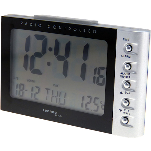Un reloj despertador digital radiocontrolado plateado y negro que muestra hora, fecha, día y temperatura.