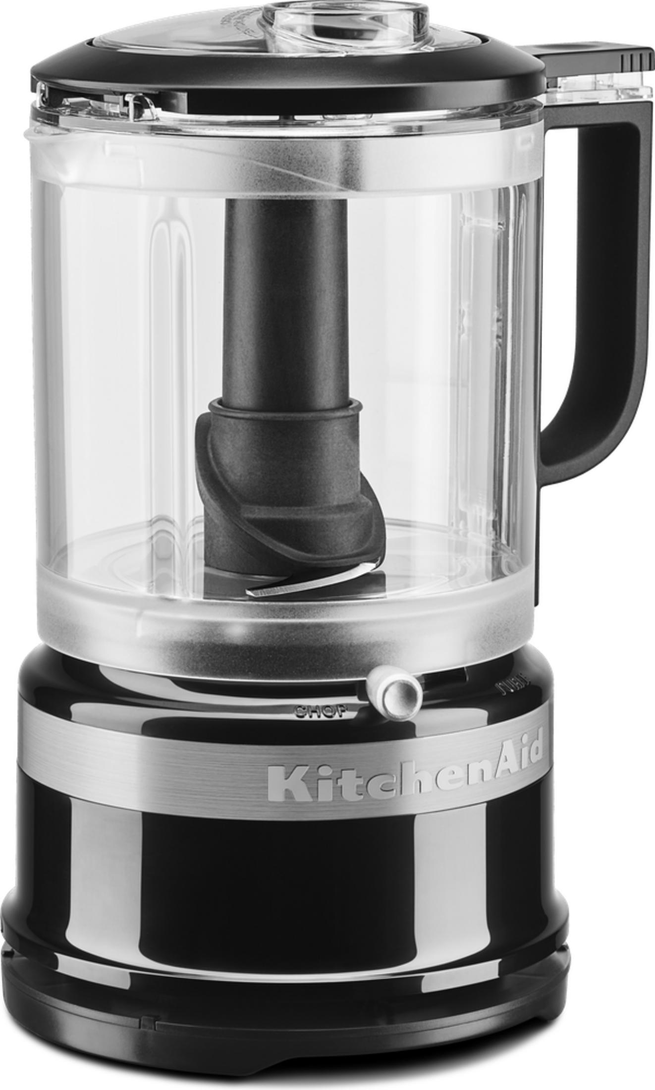 Beyaz arka planda şeffaf kasesi, siyah kulpu ve gümüş detayları olan siyah bir KitchenAid mutfak robotu.