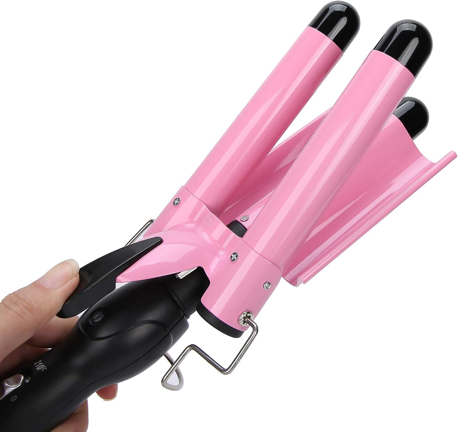 Hand hält einen dreifachen Lockenstab mit rosa Zylindern und schwarzem Griff gegen einen weißen Hintergrund.