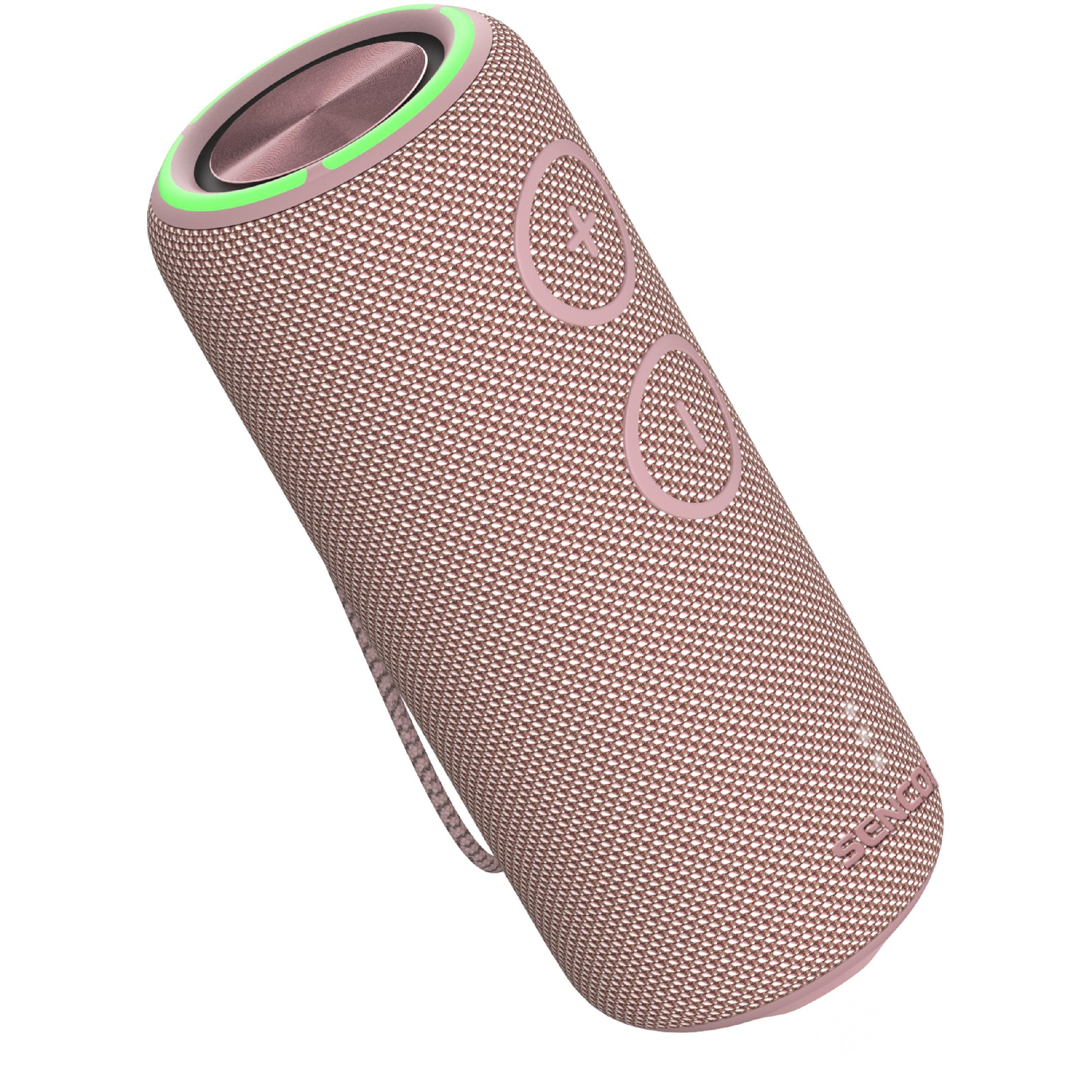 Cylindryczny różowy głośnik Bluetooth z zielonym pierścieniem świetlnym i dużymi przyciskami głośności z przodu.
