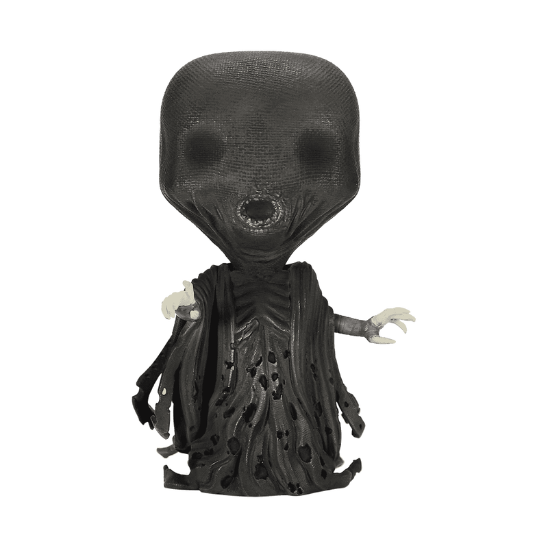 Una figura in vinile nera con testa grande, bocca aperta e vesti logore su sfondo bianco.