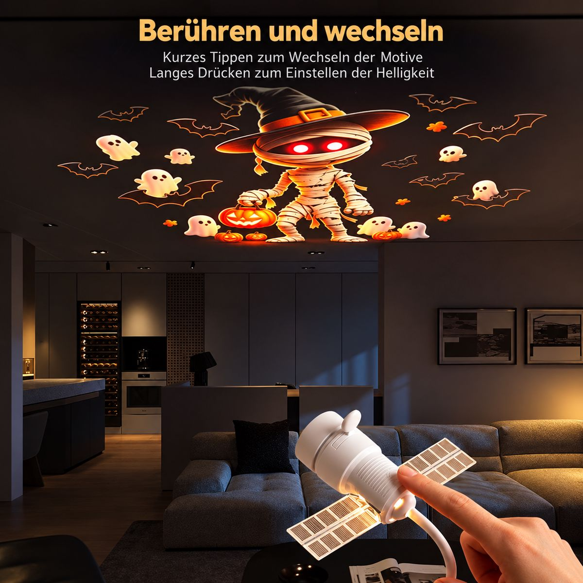 Eine Hand berührt eine weiße Satellitenlampe, die Halloween-Motive an die Zimmerdecke projiziert.