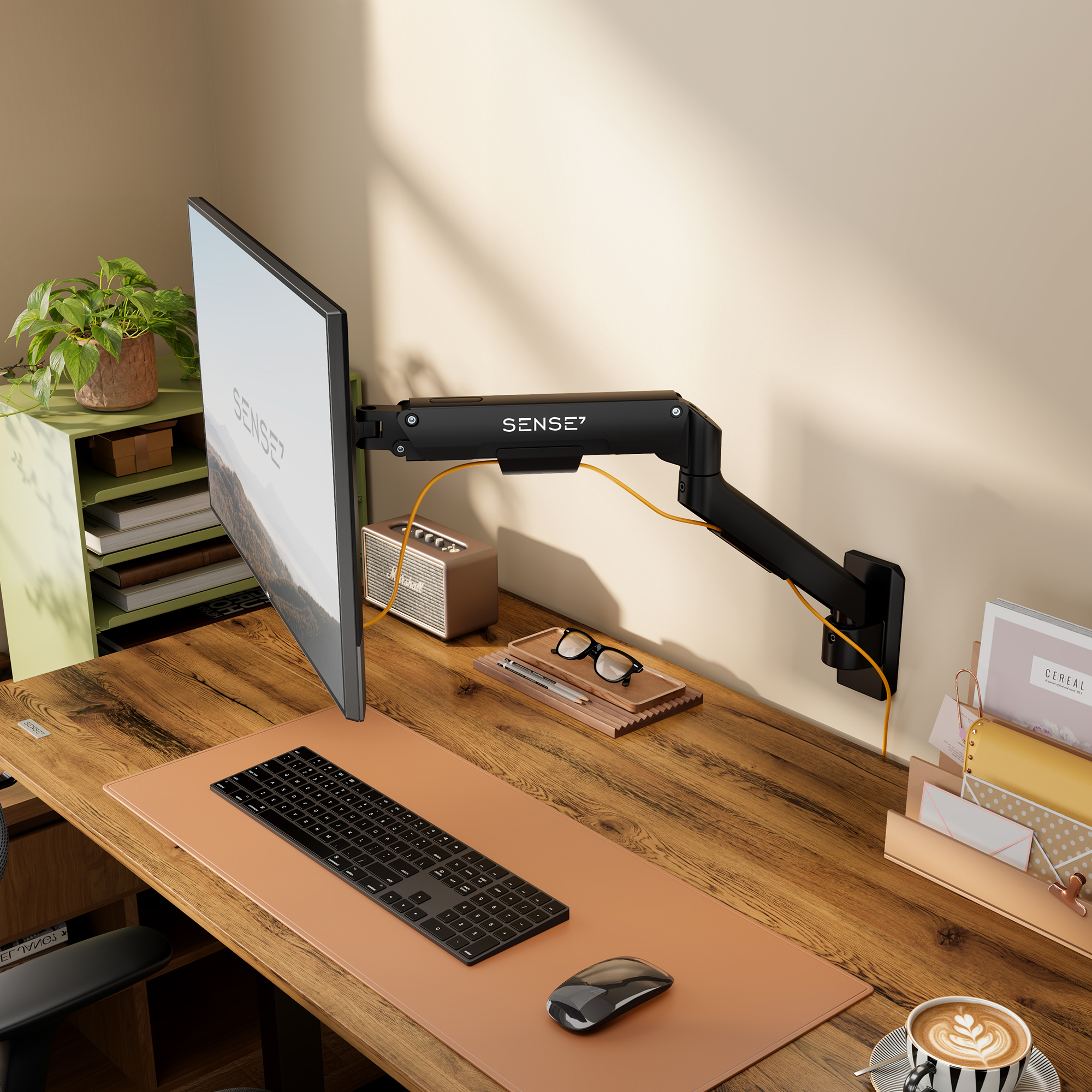 Ein schwarzer Monitorarm an einer Wand, montiert an einem Holztisch mit Tastatur, Maus und Zubehör.