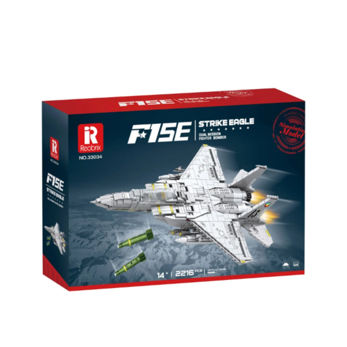 Eine Spielzeugbox zeigt einen weißen Kampfjet F15E, der Raketen abfeuert, vor einer Bergkulisse.