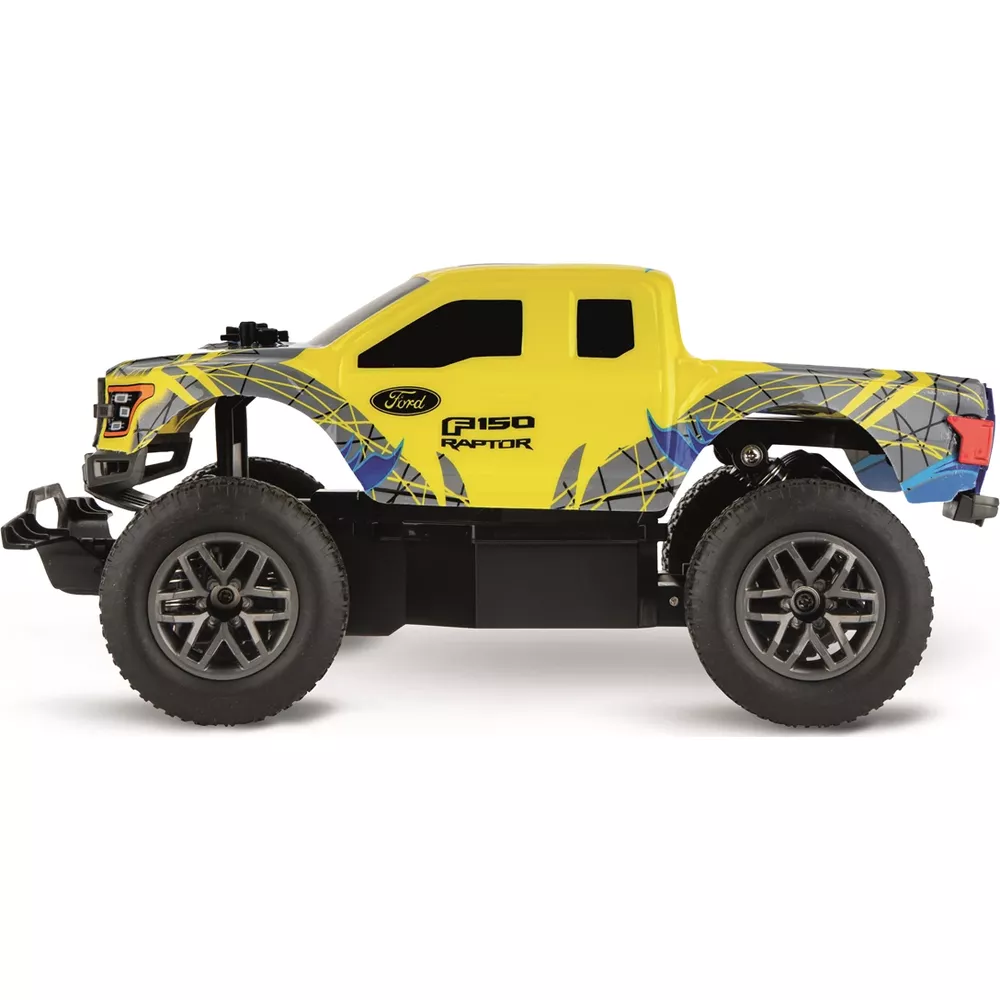 Perfil de un camión RC Ford F-150 Raptor amarillo con patrones grises y azules, neumáticos grandes y chasis negro.