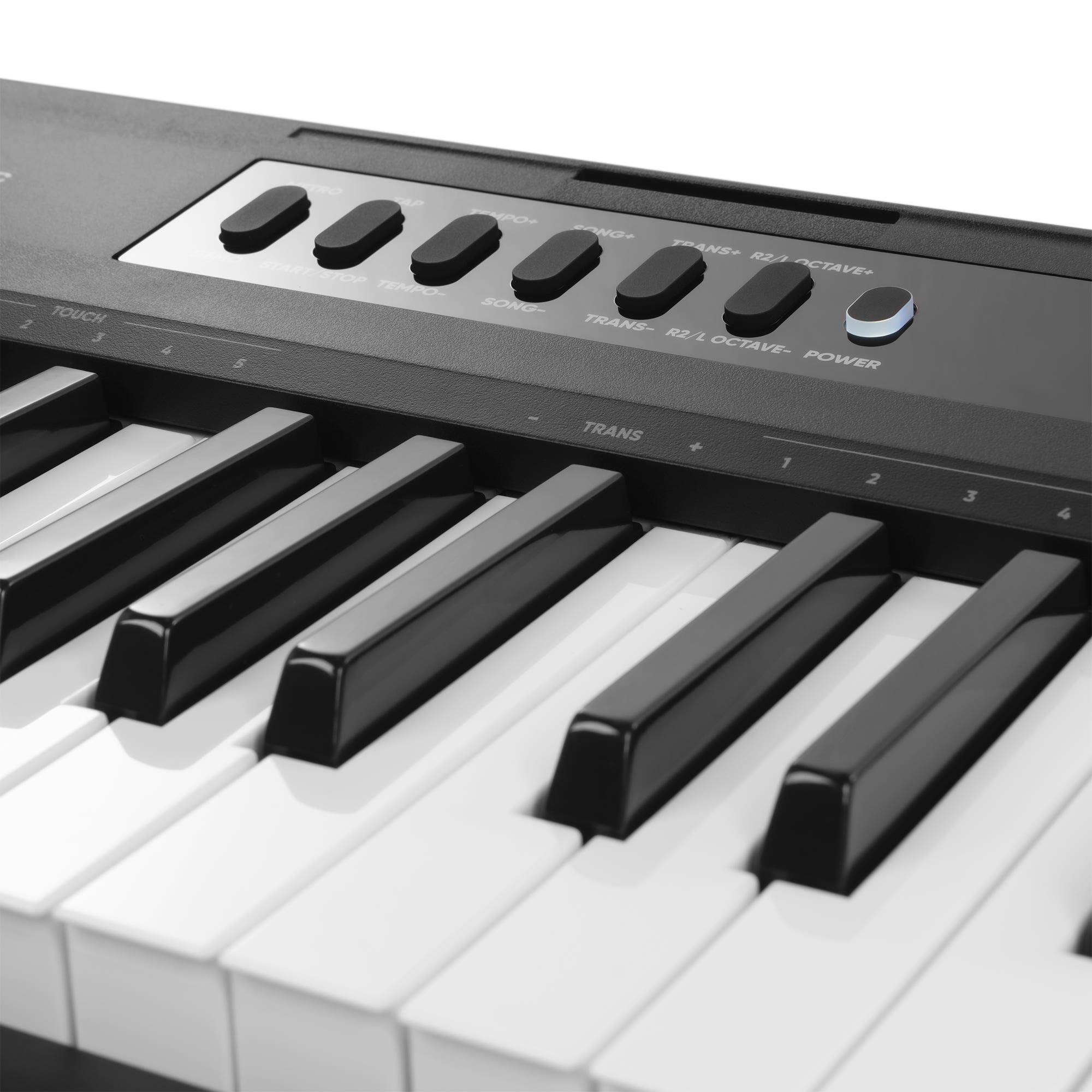 Nahaufnahme eines elektronischen Keyboards mit schwarzen und weißen Tasten sowie Kontrollknöpfen.