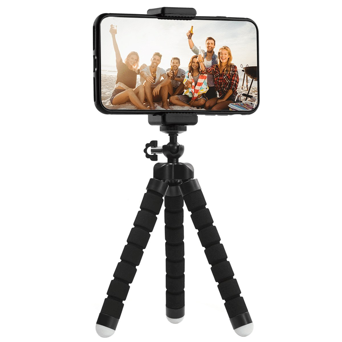 A smartphone mounted on a flexible black mini tripod with foam legs, displaying a photo of a group of friends on a beach.