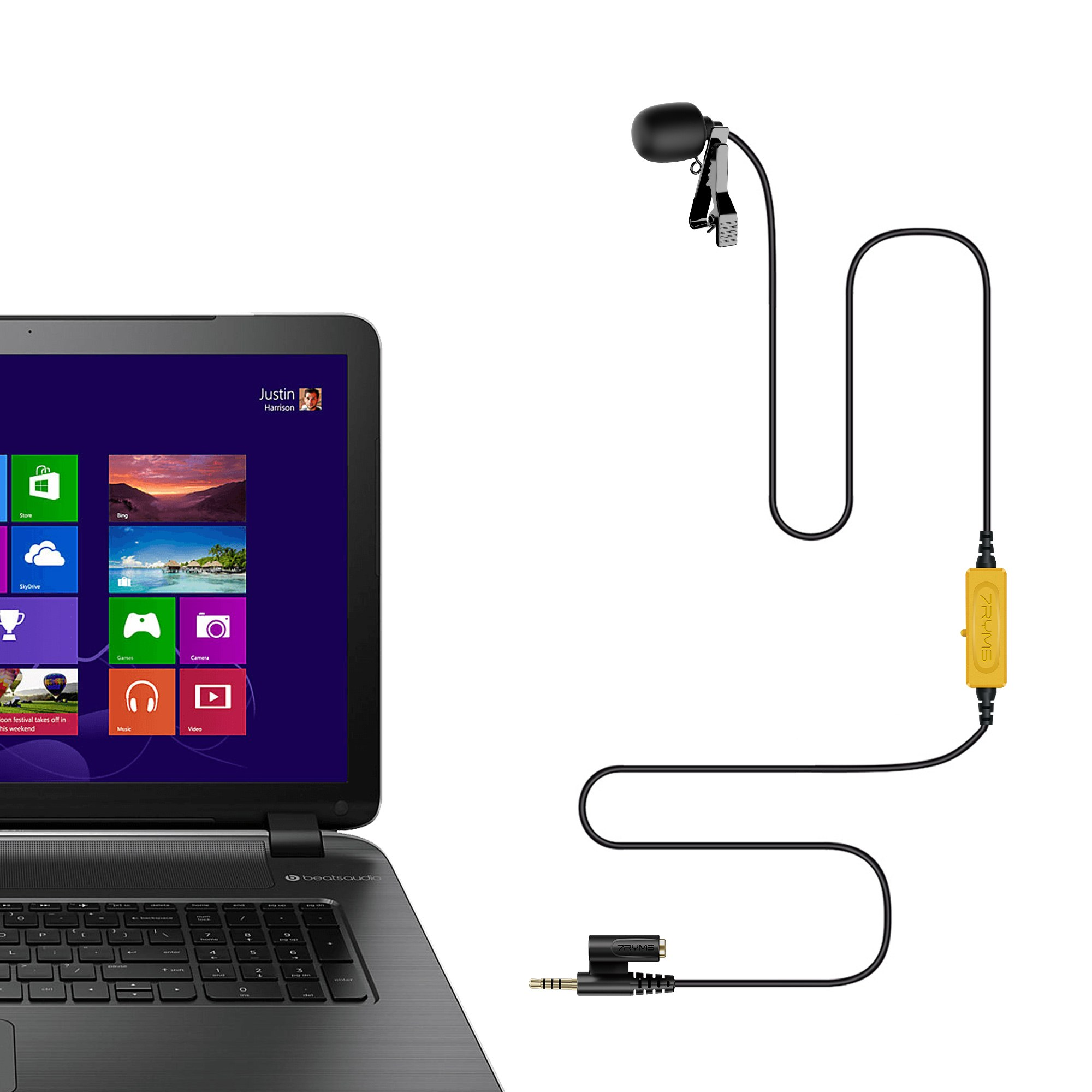 A black laptop next to a lapel microphone with a yellow module and cable.
