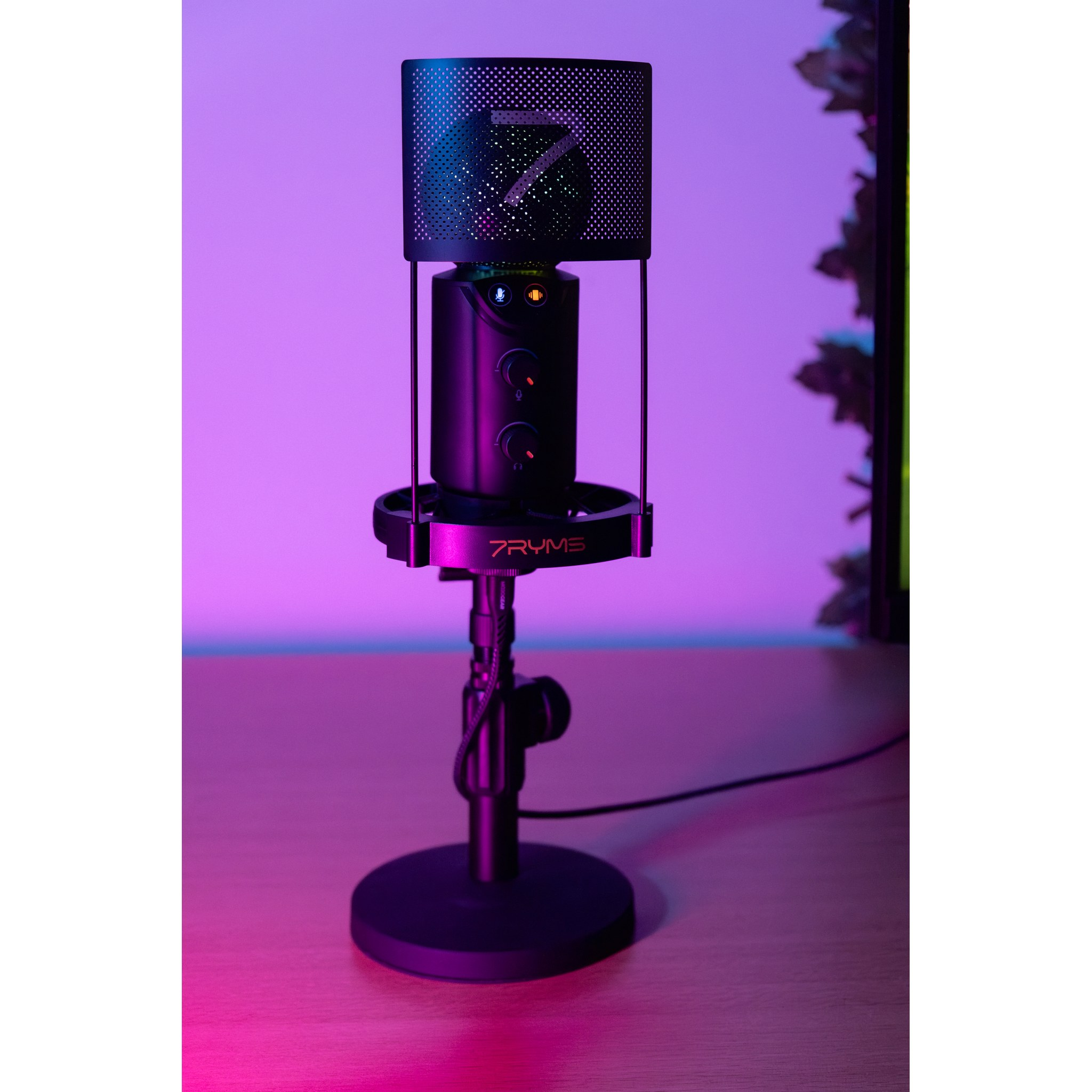 A black 7RYMS microphone on a stand, lit with purple and blue ambient light on a wooden desk.
