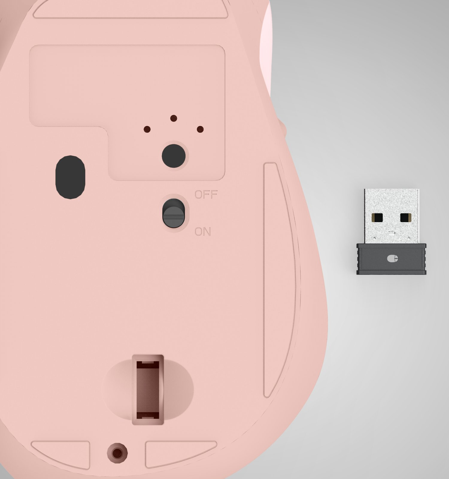 Vista inferiore di un mouse rosa con interruttore di accensione e un ricevitore USB accanto.