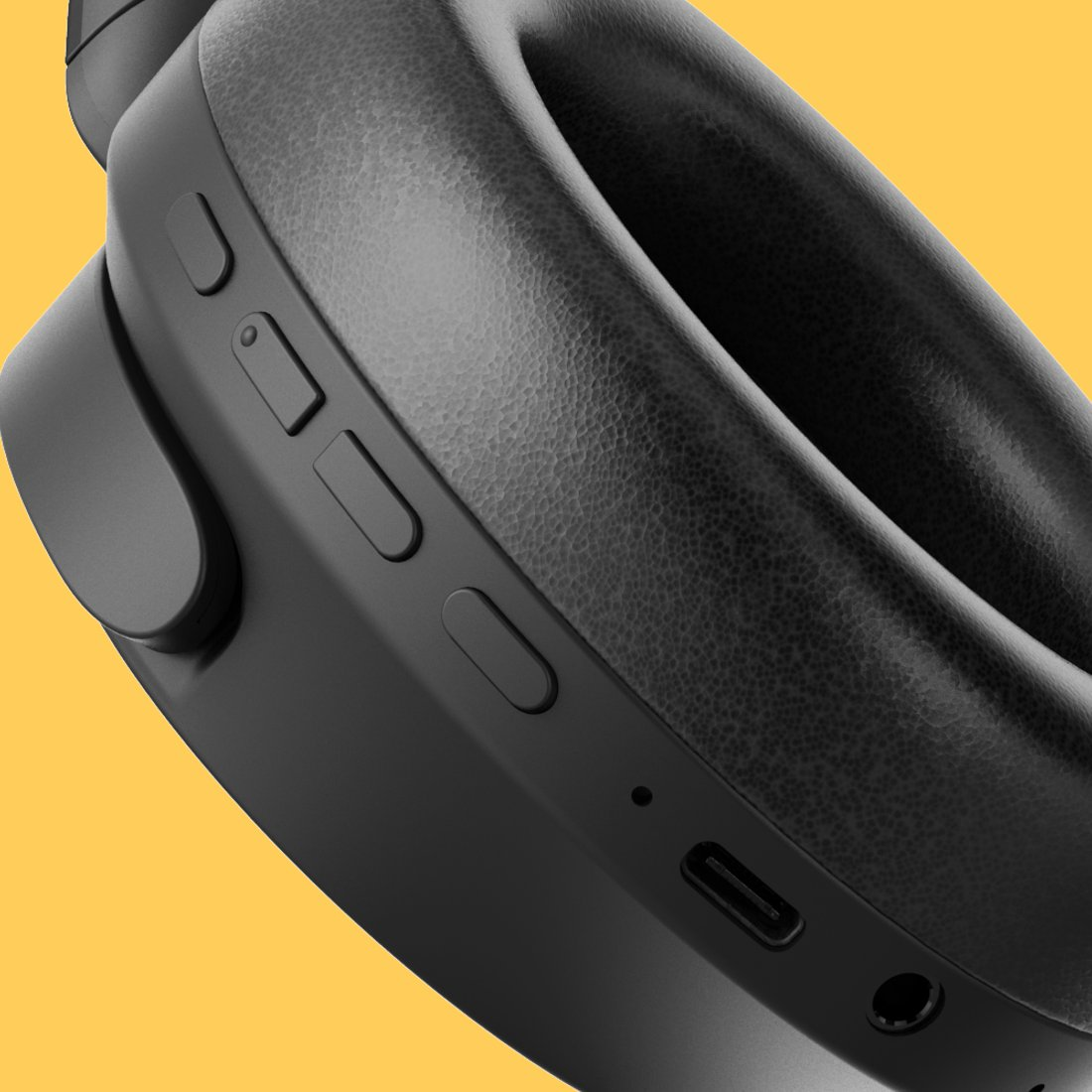 Schwarze Kopfhörermuschel mit Kontrolltasten, USB-C-Anschluss und Audiobuchse vor gelbem Hintergrund.