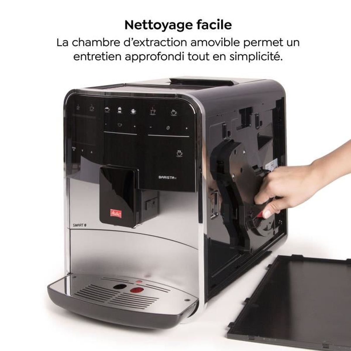 A hand removes the brewing unit from a modern black and silver coffee machine.