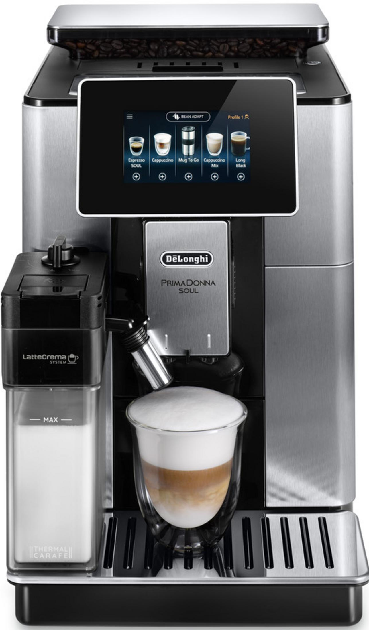 A silver and black DeLonghi coffee machine brews a layered latte macchiato in a clear glass.