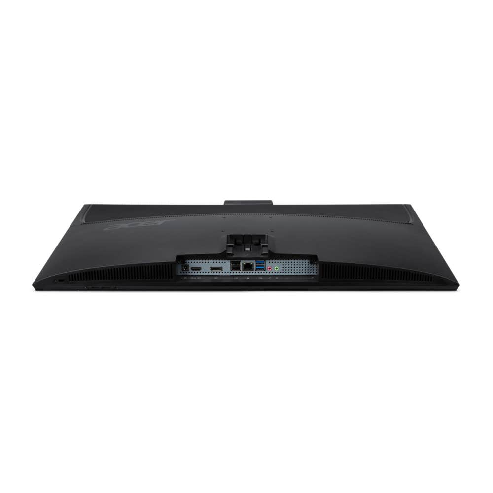 Vista posteriore di un monitor nero che mostra varie porte di ingresso e griglie di ventilazione su sfondo bianco.