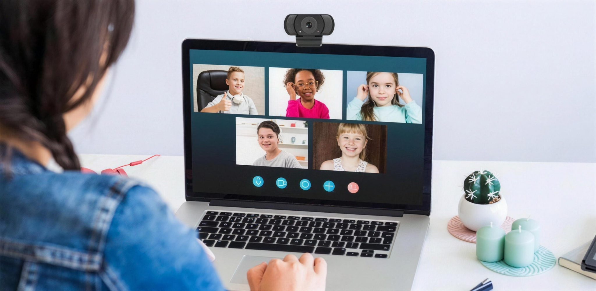 Eine Person nutzt einen Laptop für einen Videoanruf mit fünf Kindern auf dem Bildschirm.