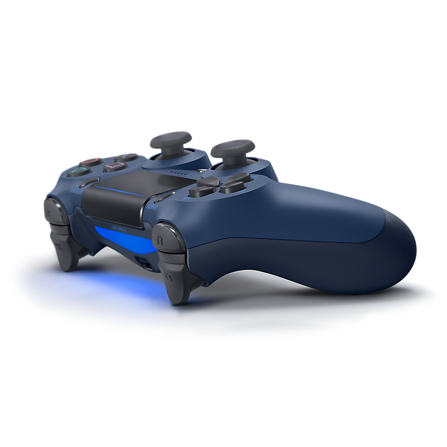 A blue PlayStation 4 controller rests on a white surface with a blue light glowing at the front.