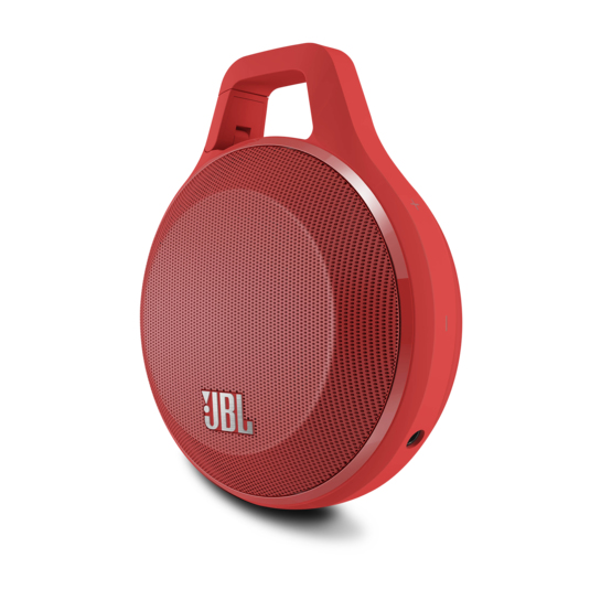 Ein roter tragbarer JBL-Lautsprecher mit integriertem Griff vor weißem Hintergrund.