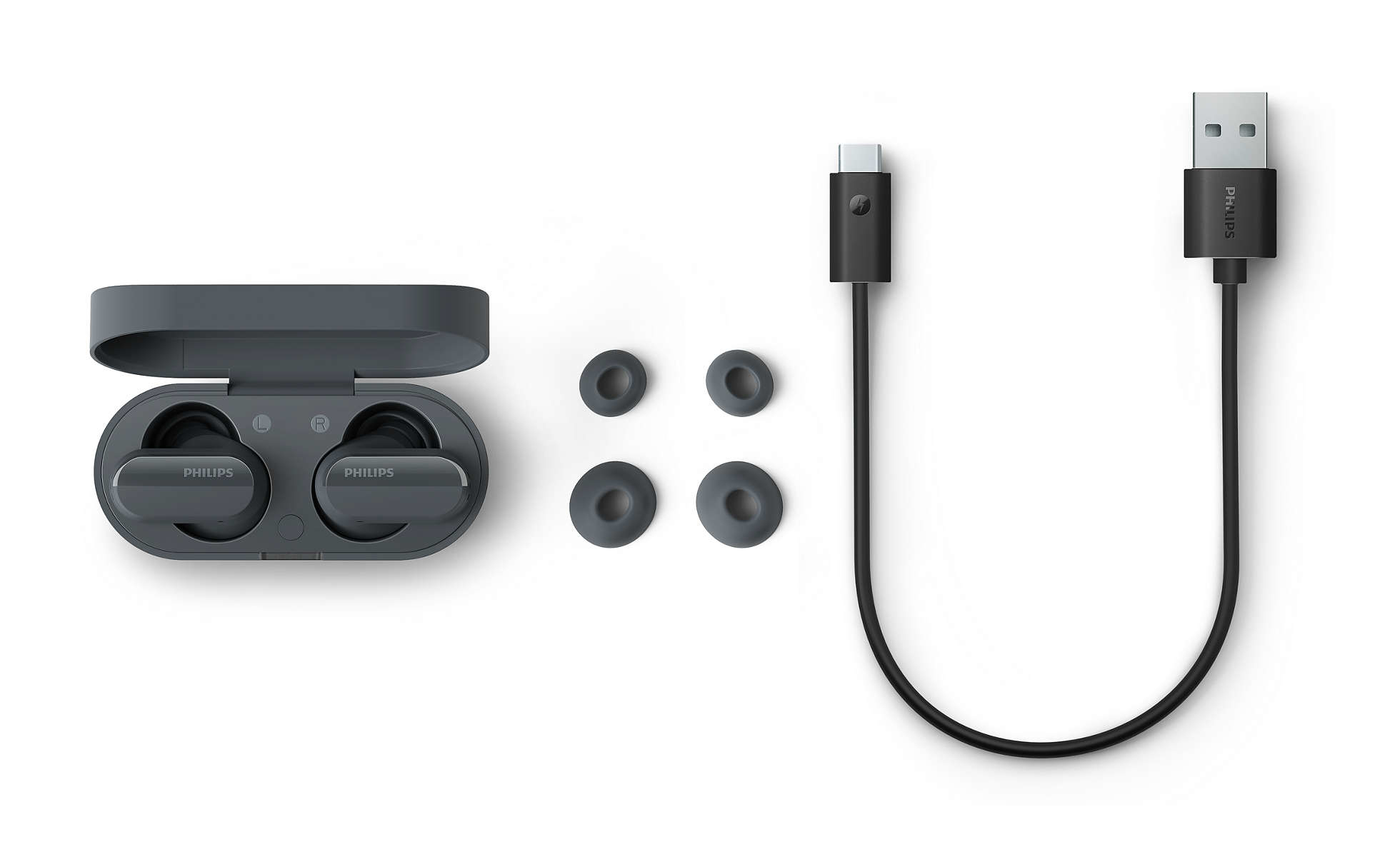 Graue Philips-Ohrhörer in Ladecase mit Ersatzaufsätzen und USB-Kabel.