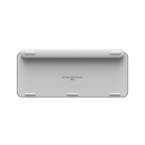 Bottom view of the MX Keys Mini for Mac wireless keyboard, showing rubber feet and product text on a white background.