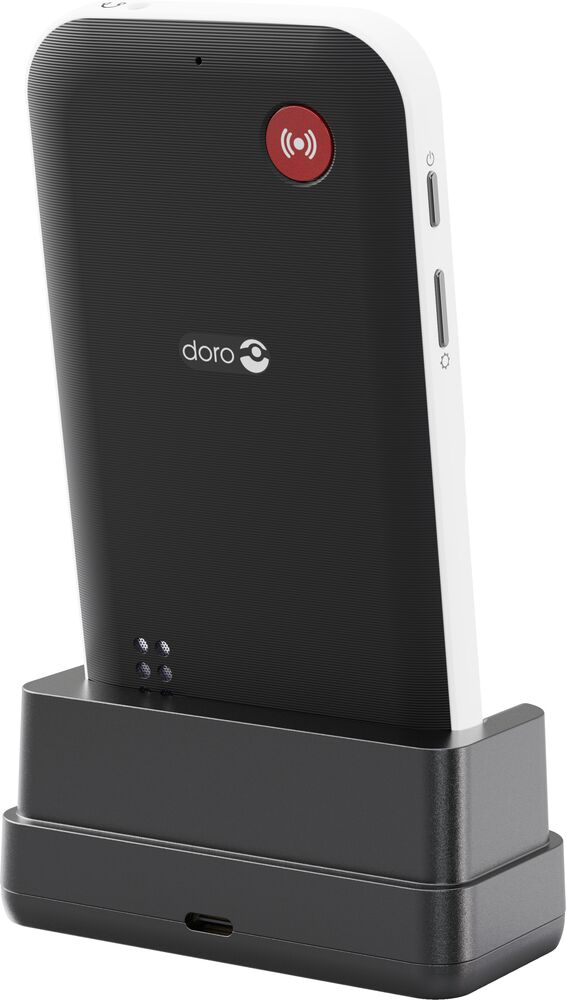 Retro di uno smartphone Doro nero in una base di ricarica nera su sfondo bianco.