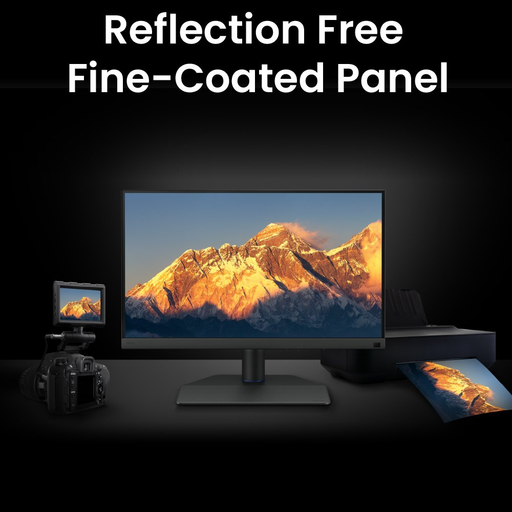 A monitor displaying a mountain landscape, flanked by a camera on the left and a printer with a photo on the right.