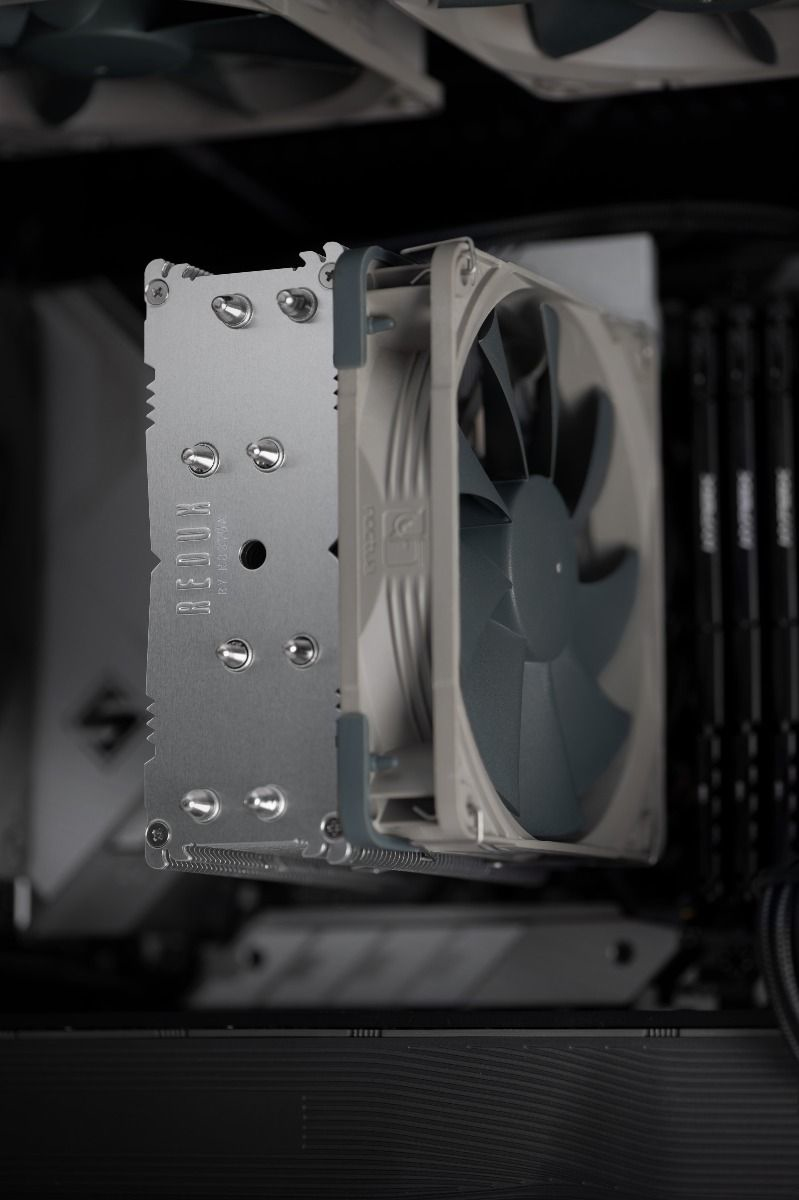 Un dissipatore CPU argento con ventole grigie in un PC.