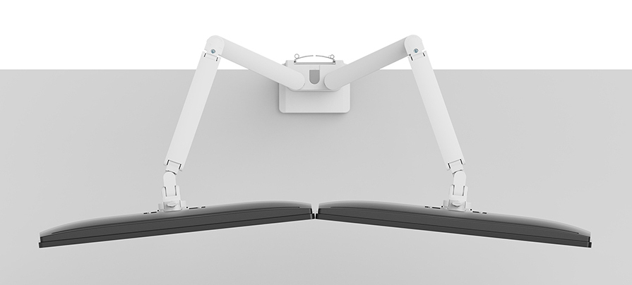 Top-down view of two white monitor arms mounted on a grey wall holding screens.