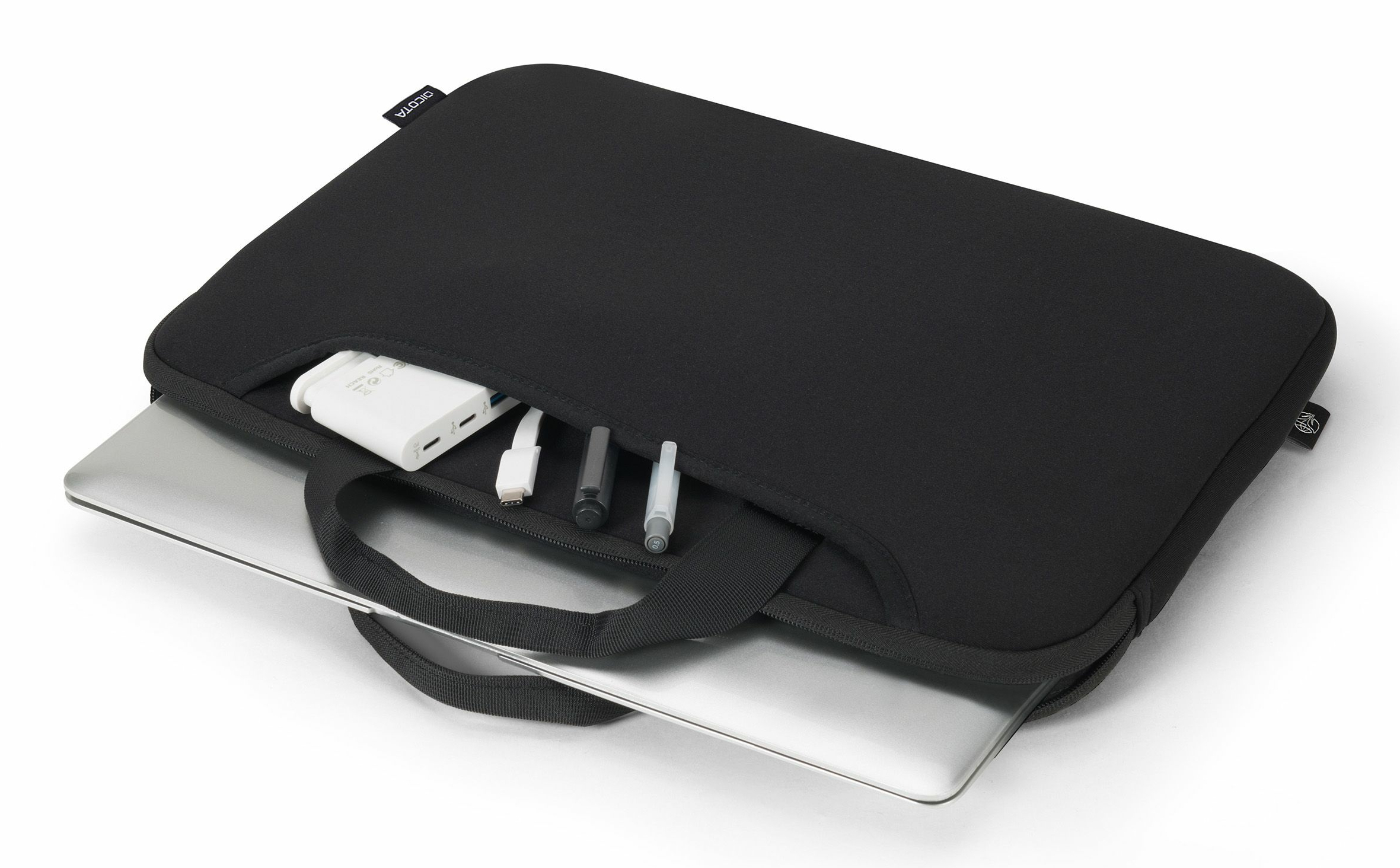 A black laptop sleeve holding a laptop, with a charger and pens in the front pocket, against a white background.