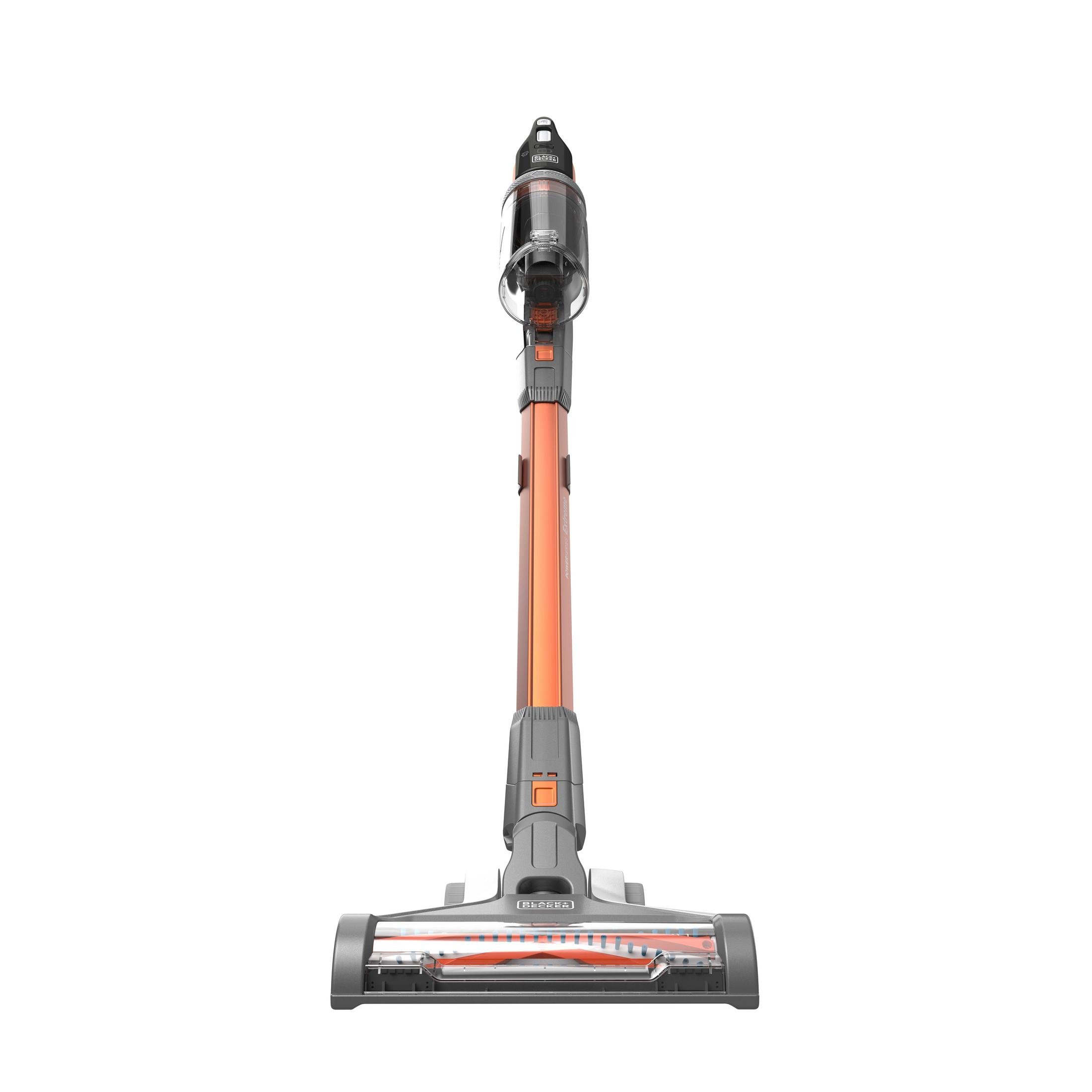 A grey and orange cordless stick vacuum stands upright against a white background.