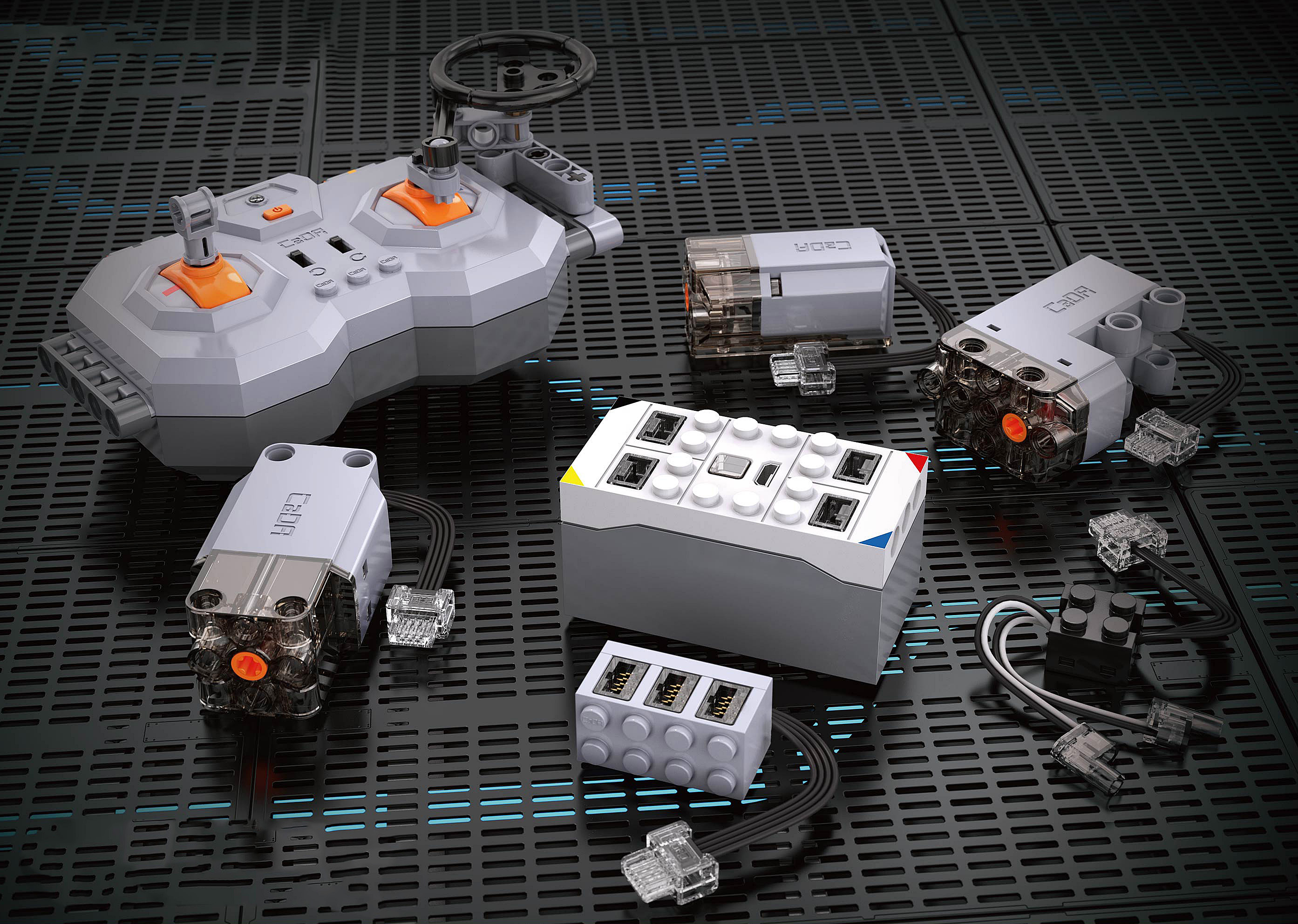 Graue Baustein-Elektronikkomponenten inklusive Fernbedienung, Motoren und Akkubox auf schwarzem Untergrund.
